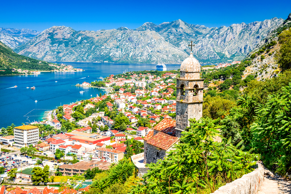 Panoramic view overlooking Kotor and the Adriatic Sea on a sunny day.