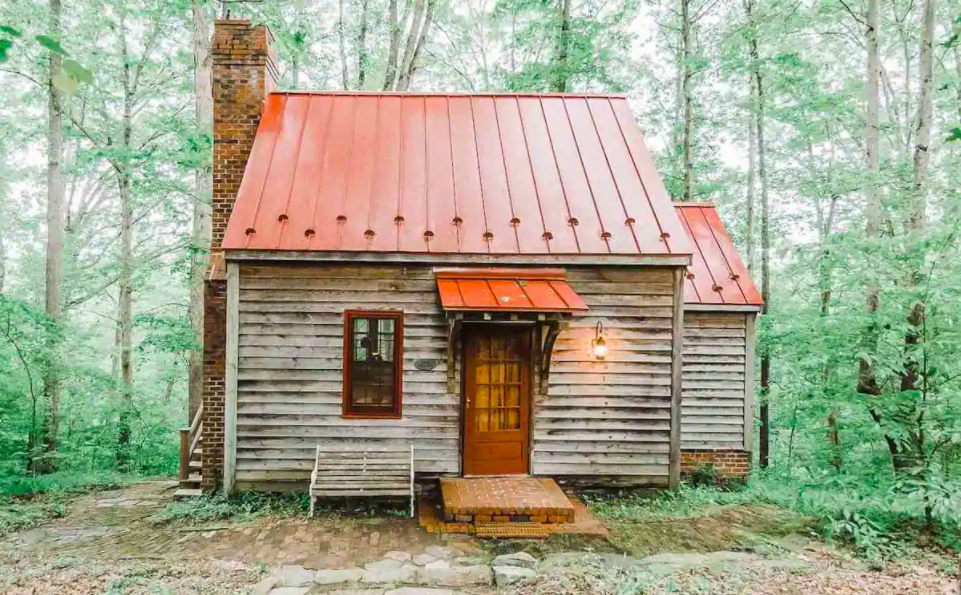 adorable run down cabin with orange metal roof makes it one of the coziest cabins in Virginia.