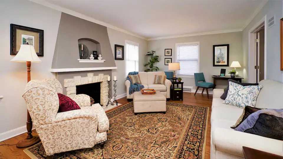 One of the best Airbnbs in Kansas City Missouri has a beautiful living room with plush oversized furniture and large rug!