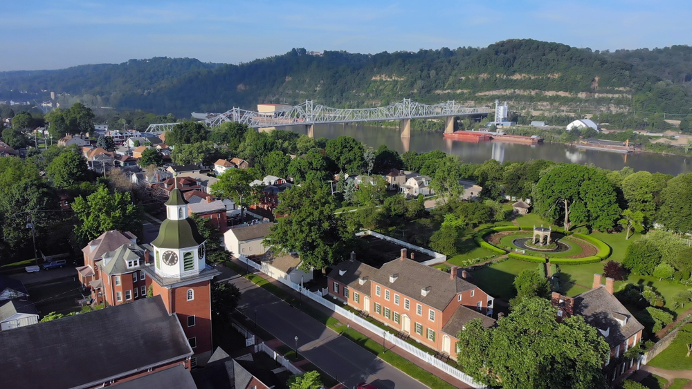an aerial shot of a town in Pennsylvania, Ambridge with the Ohio River and rolling hills in background.