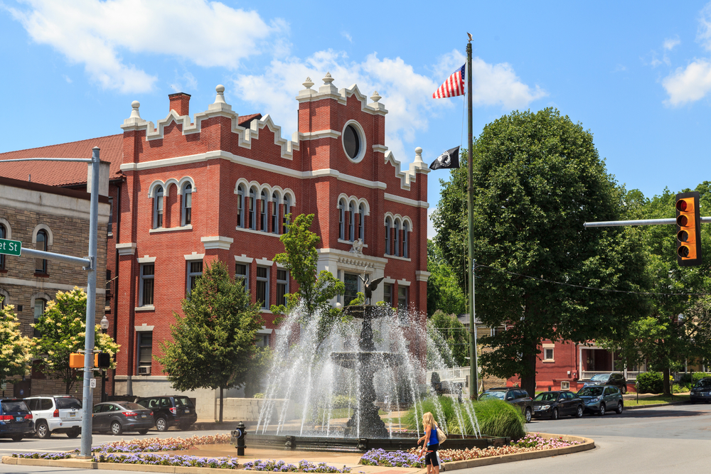 Bloomsburg a town in Pennsylvania with a beautiful fountain and vintage red-brick building in the distance.