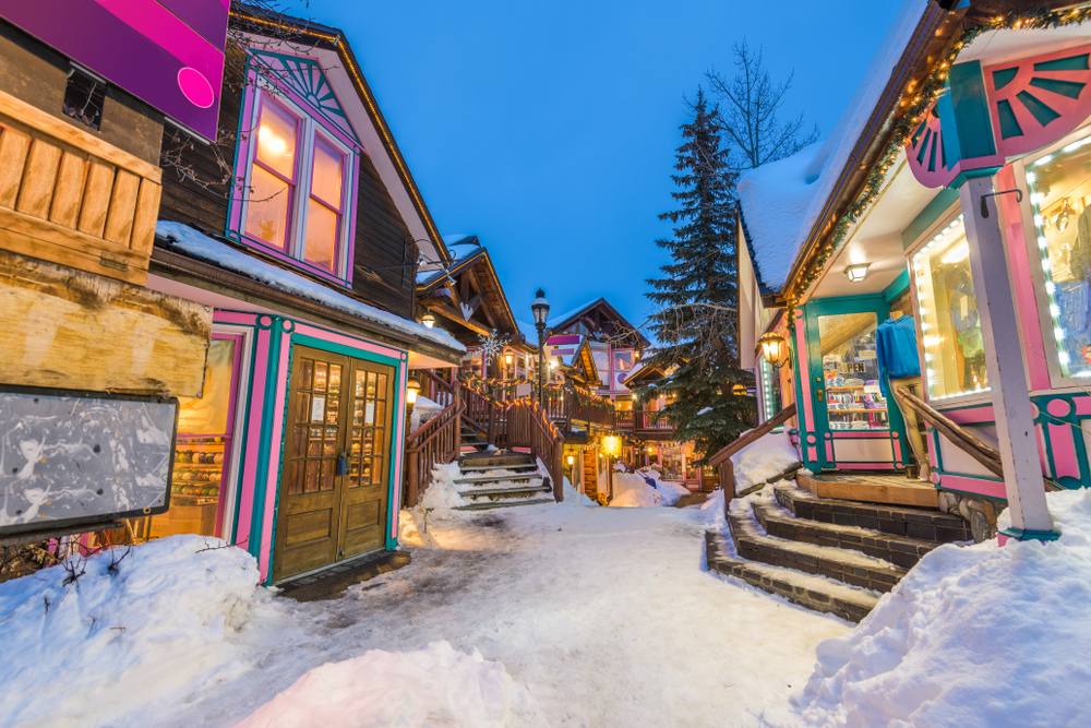 Pink and blue cute building on a show covered road in Breckenridge Christmas vacations in the USA