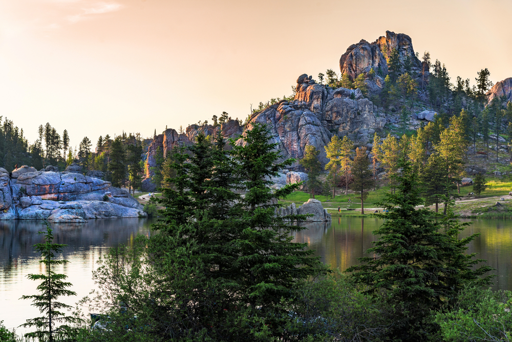 Rocks around a lake with trees in a state park in South Dakota. One of the romantic getaways in the Midwest. 