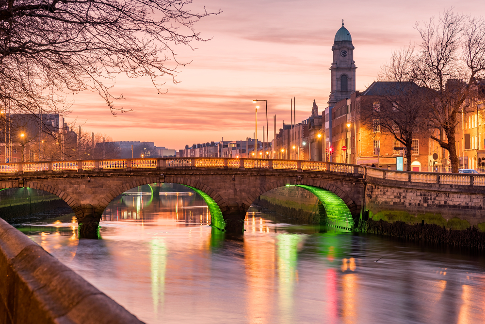Grattan Bridge in Dublin, Ireland on the evening .This historic bridge spans the River Liffey in Dublin, Ireland. The bridge is lit up with green light. See this when spending 2 days in Dublin