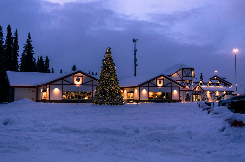 houses with a christmas tree covered in snow towns in alaska