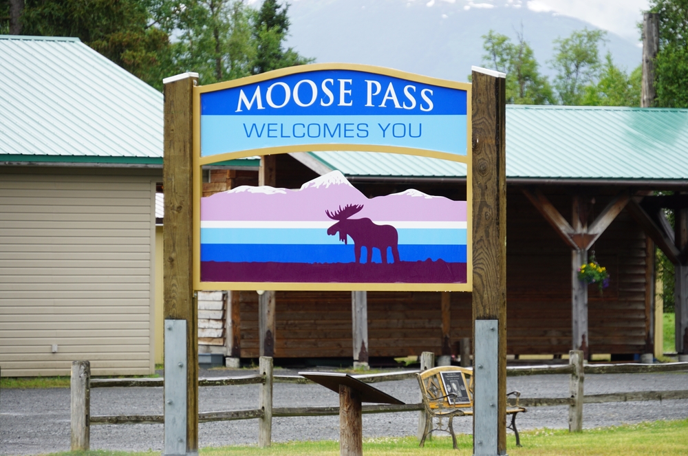 sign board saying moose pass welcomes you anchorage to seward