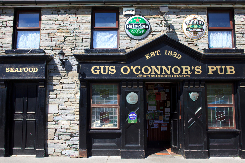 gus o'connor's pub board on a brick walled building