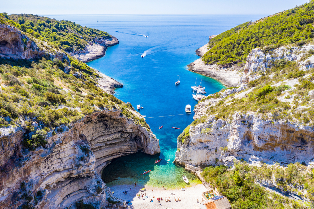 aerial view of a beautiful beach surrounded by cliffs day trips from split
