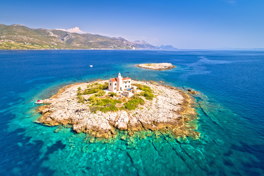 isolated island in clear blue ocean day trips from split