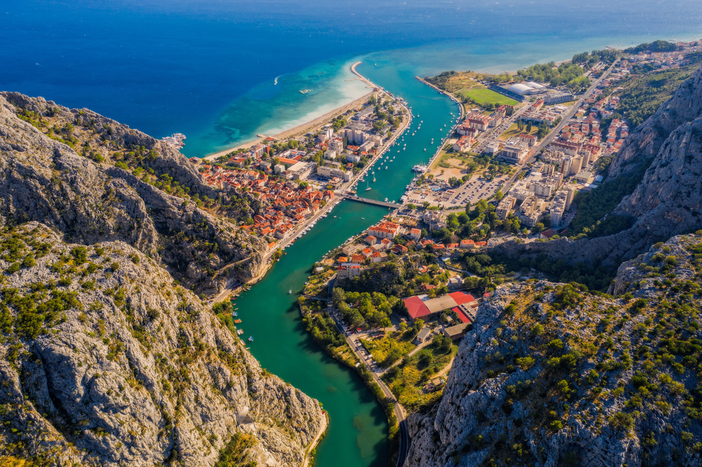 panorama view of a coastal town surrounded by mountains day trips from split