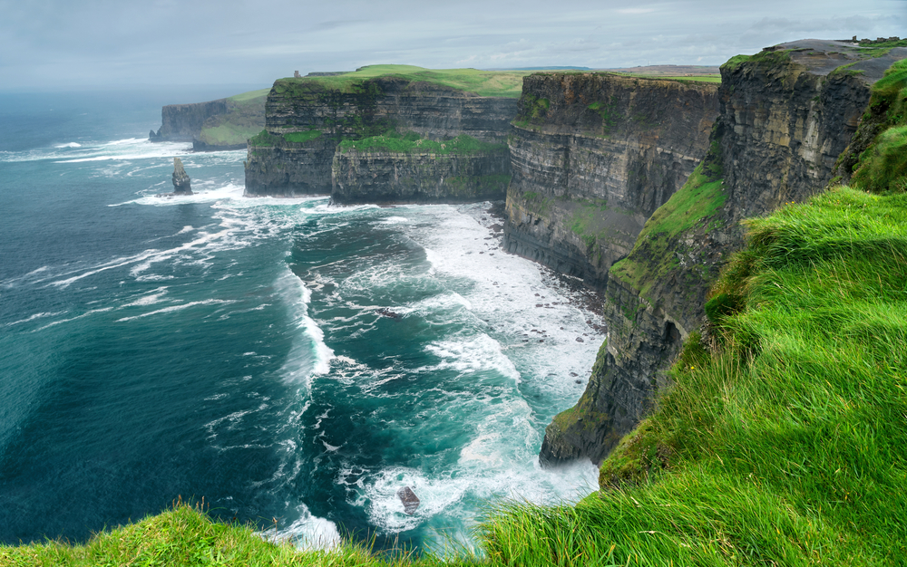 cliffs beside a sea traveling to ireland