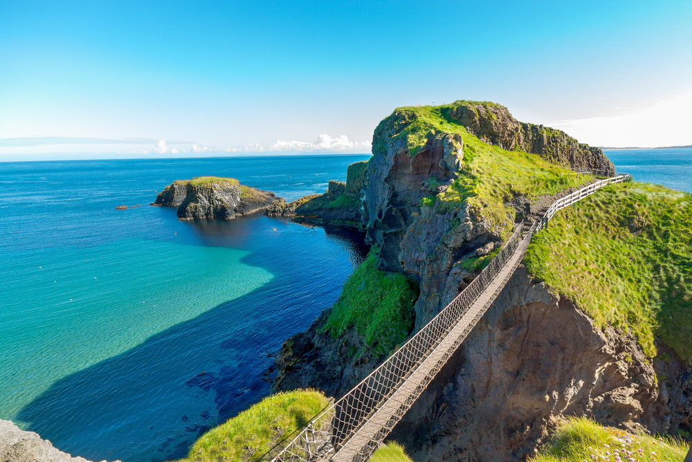 rope bridge over a sea connecting cliffs traveling to ireland