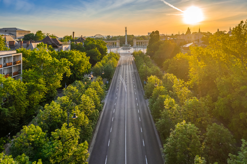 aerial view of a road lined with trees on both sides that leads to a square 2 days in budapest