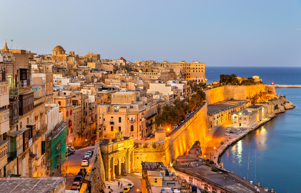 evening view of an island town lit up places to visit in malta