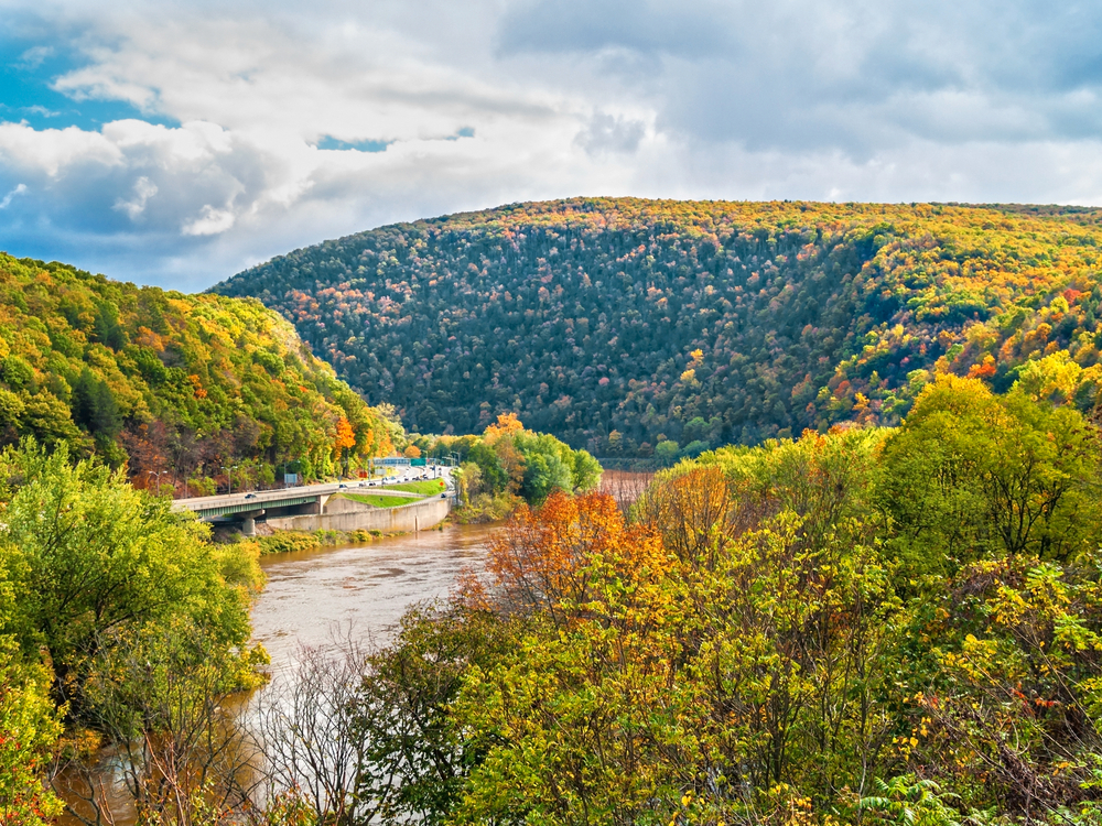 view of the river surrounded by forests and mountains towns in the pocono mountains 