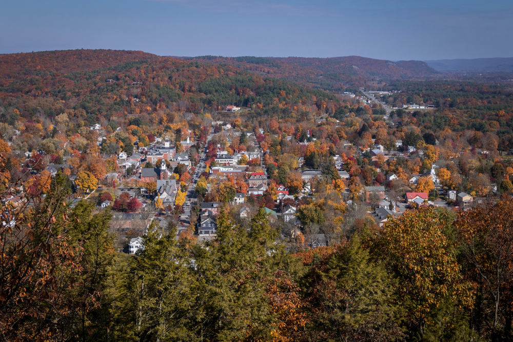 aerial view of a town surrounded by forest during autumn towns in the pocono mountains 