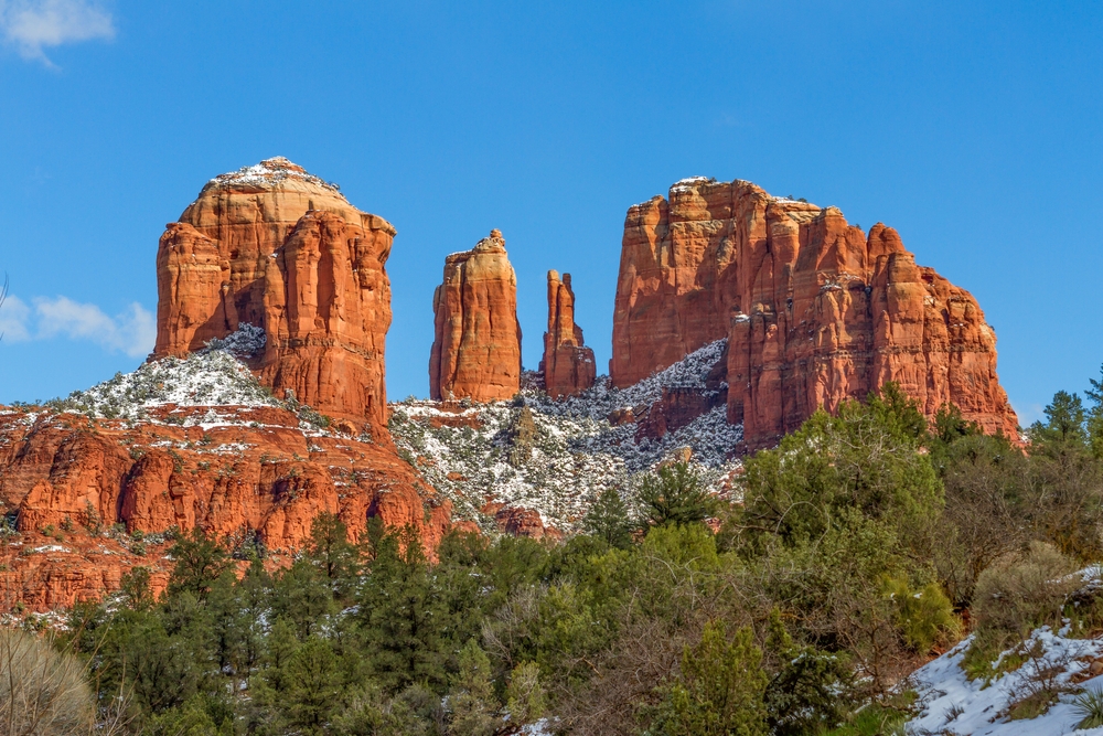 red colored rocks surrounded by trees romantic getaways in the USA