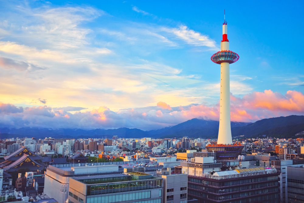 aerial view with a tower in the city surrounded by mountains best things to do in kyoto