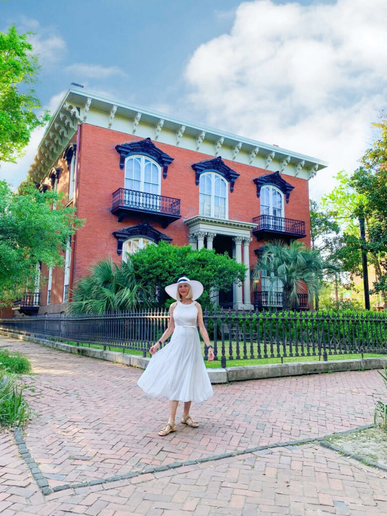 woman in front of the garden of a museum house