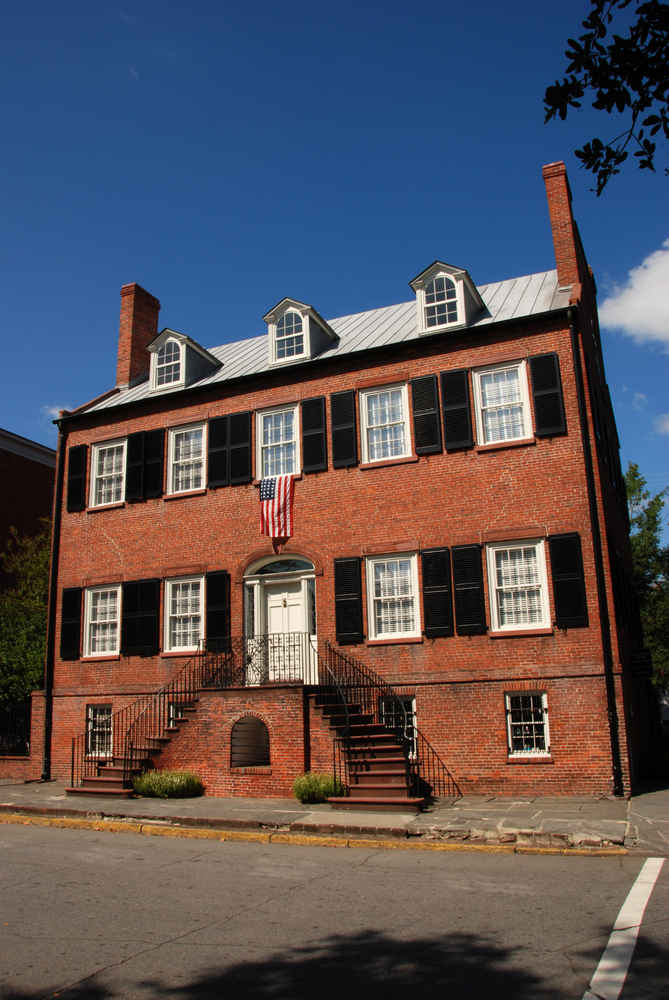 red brick building with white windows and roof