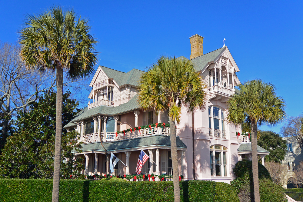 house decorated with christmas decorations with USA flag waving christmas in charleston