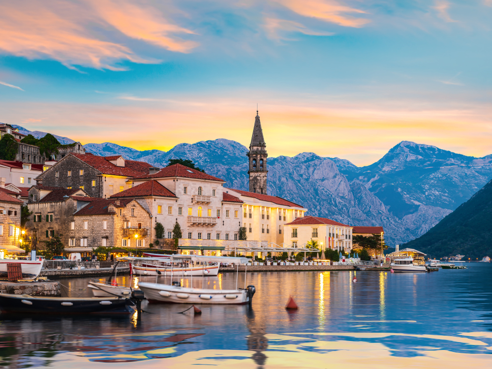 houses beside a river surrounded by mountains romantic cities in europe