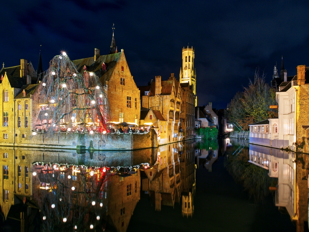 christmas lights on a building beside a river christmas vacation ideas