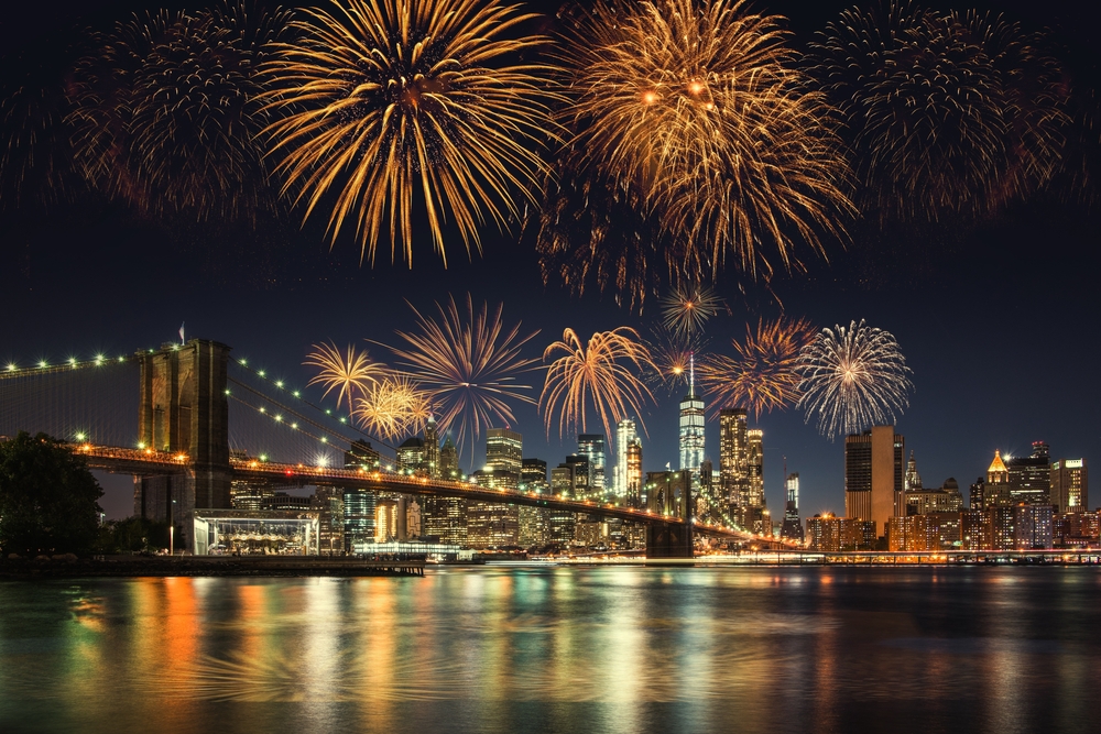 fireworks over city with bridge