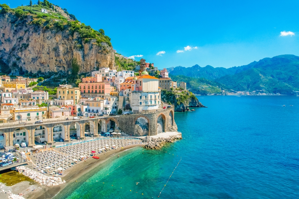 coastal town with mountains and colorful buildings summer in europe