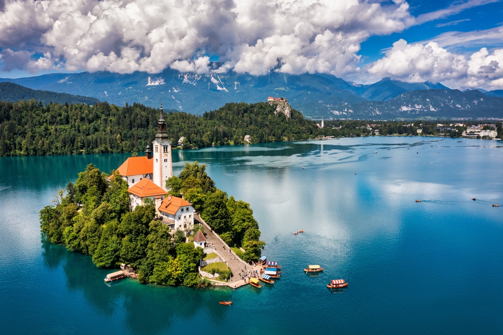 small island in a lake surrounded by mountains