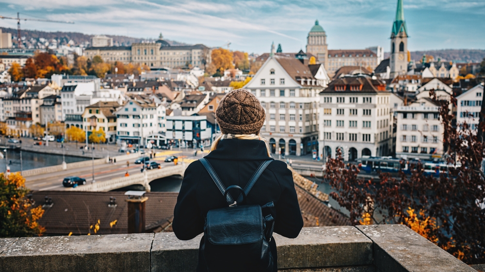 girl enjoying view of the town with woollen cap europe vacation tips