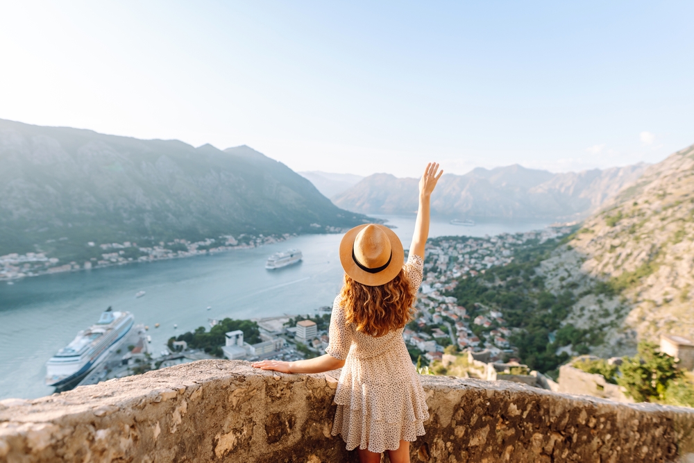 girl overlooking the view of river and mountains