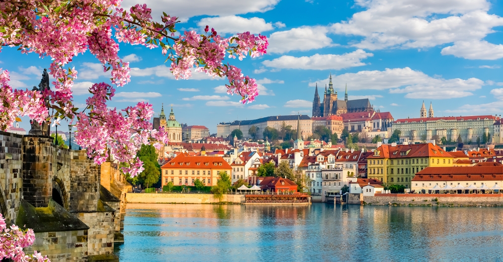 panoramic view of river with spring flowers and old buildings