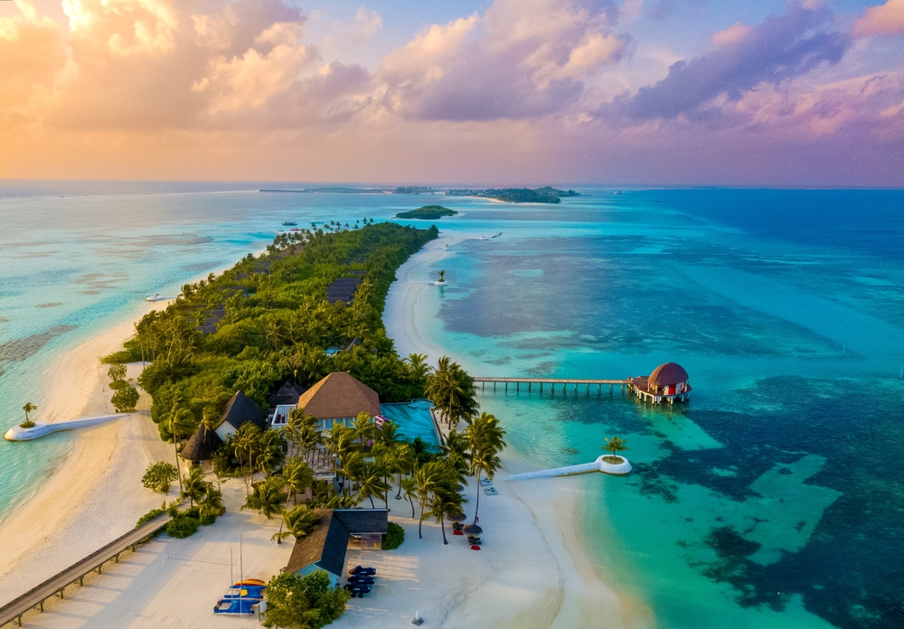 aerial view of an island with forest and a couple of stays