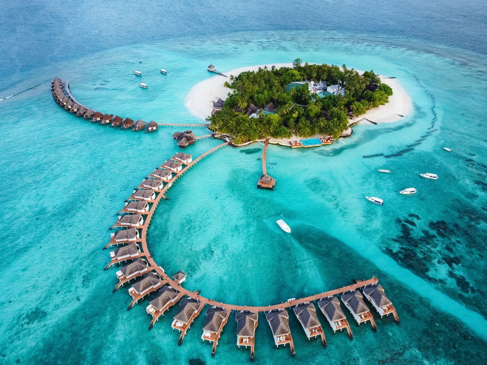 drone view of resorts in the ocean traveling to the maldives