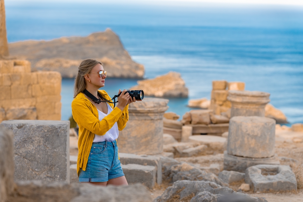 girl with a camera taking photos around