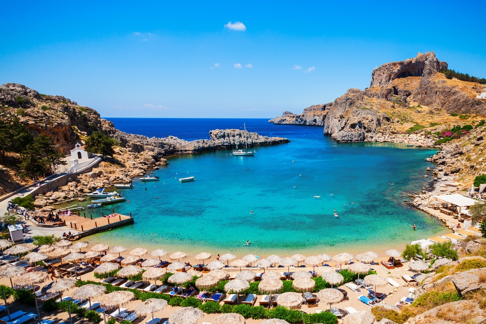 view of a beach surrounded by cliffs