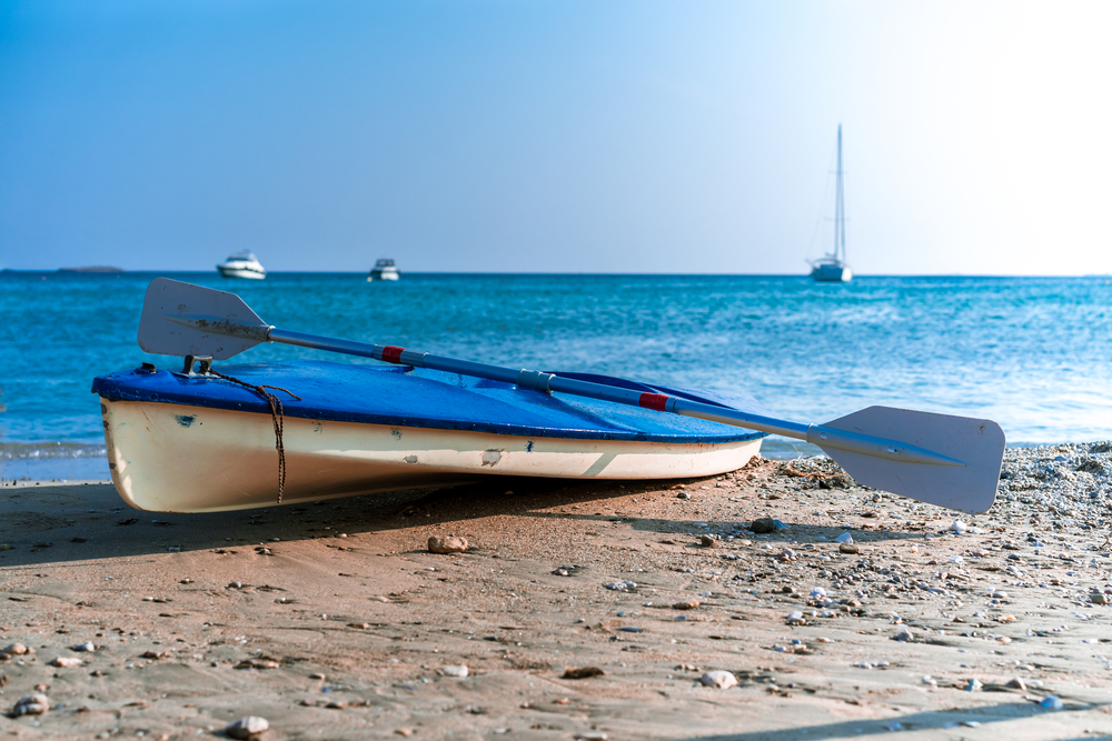 canoe kayak with oar on a beach