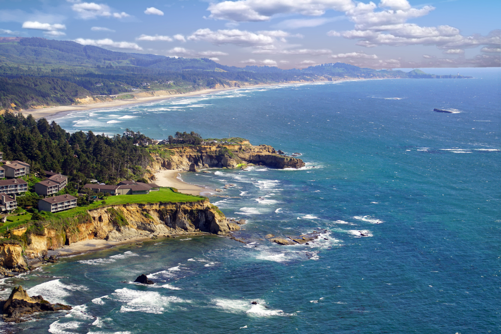houses on a cliff surrounded by trees and beaches oregon coast getaways