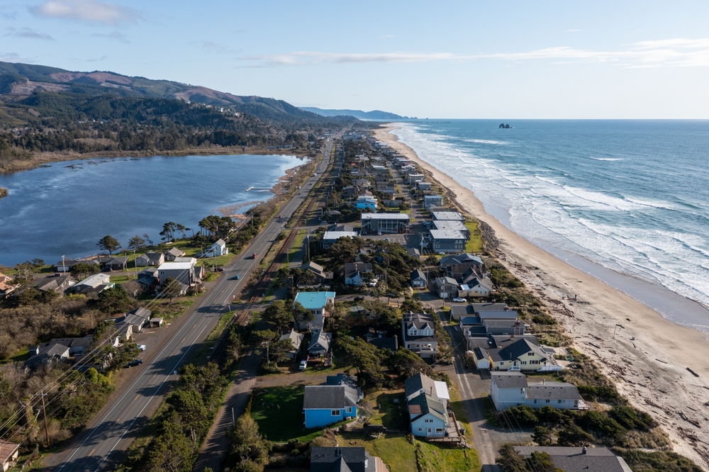 aerial view of a coastal city with a lake on one side oregon coast getaways