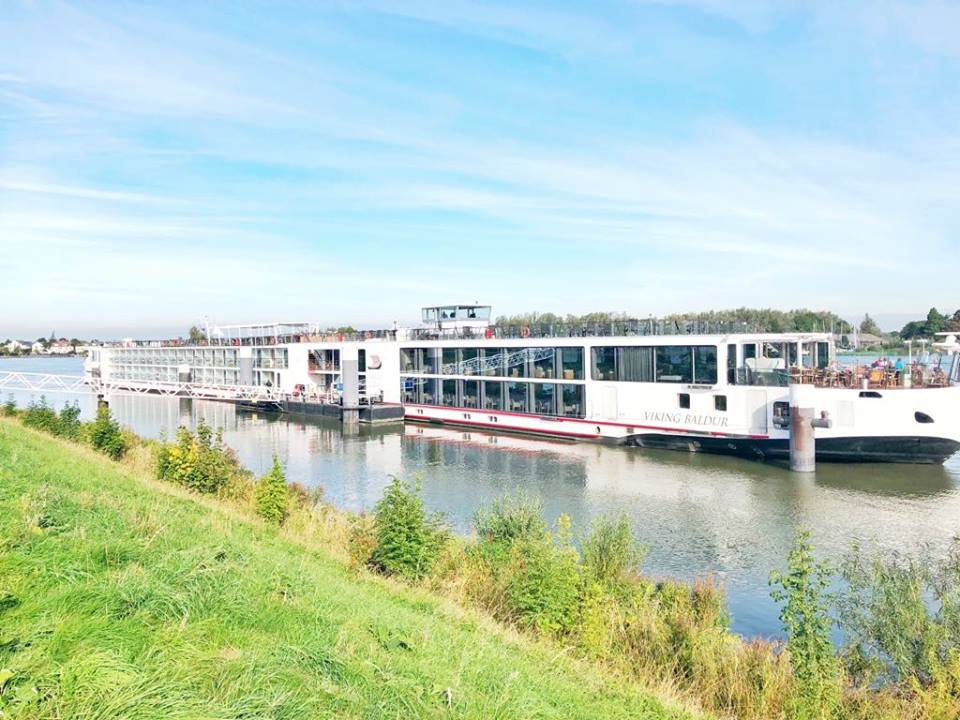 
Two Long white river cruise ships on calm waters.