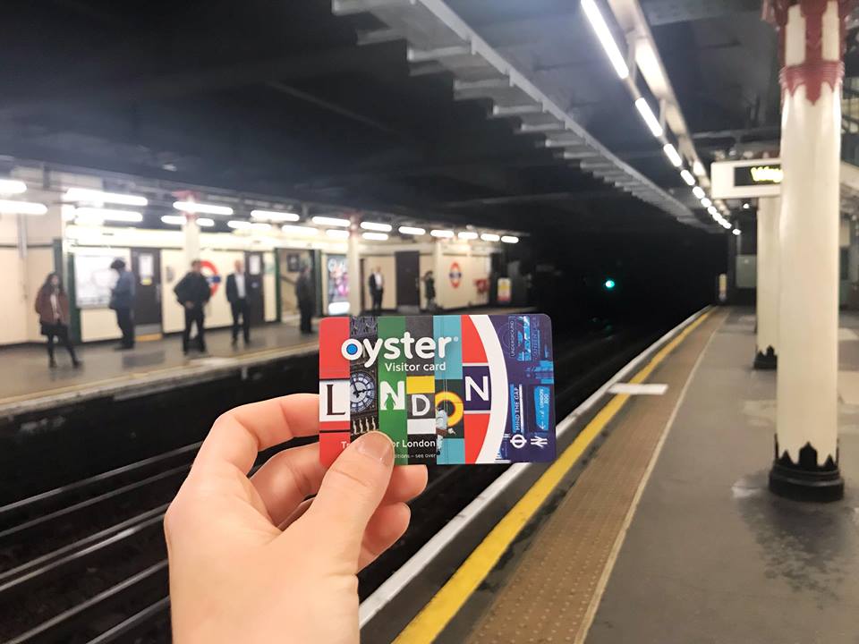 Photo of underground London Metro with female white hand holding colorful subway ticket  You need to get one of theses for your first time in London