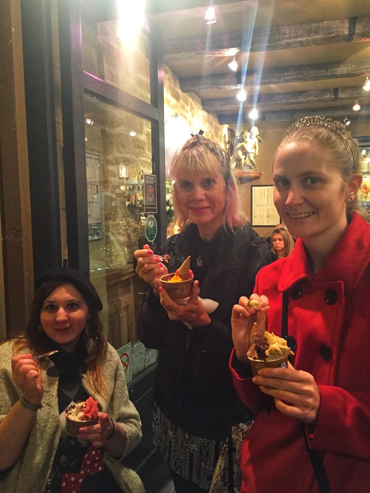 3 caucasian women eating cups of gelato 