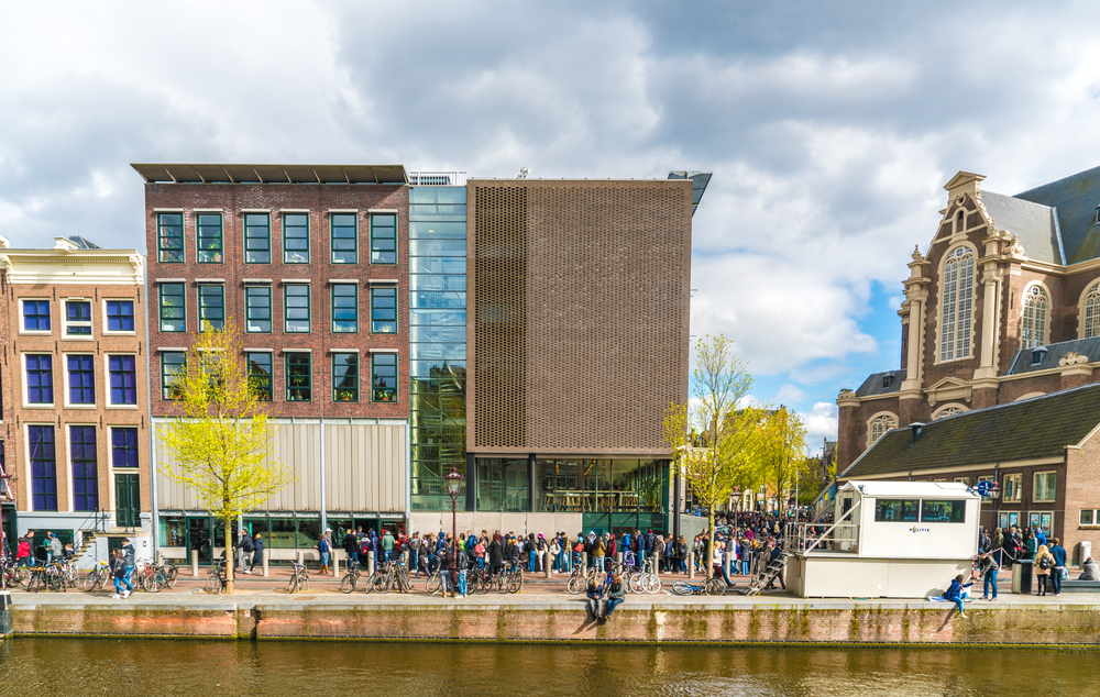 Tourists lining up to enter the Anne Frank House on a canal in Amsterdam.