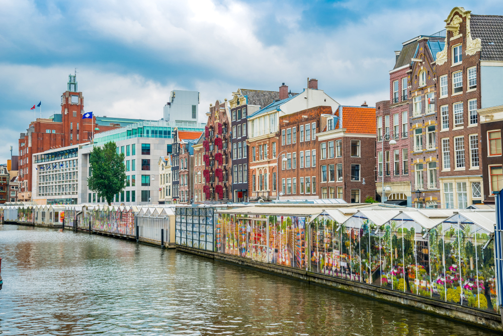 View over the water of the covered  Amsterdam Flower Market.