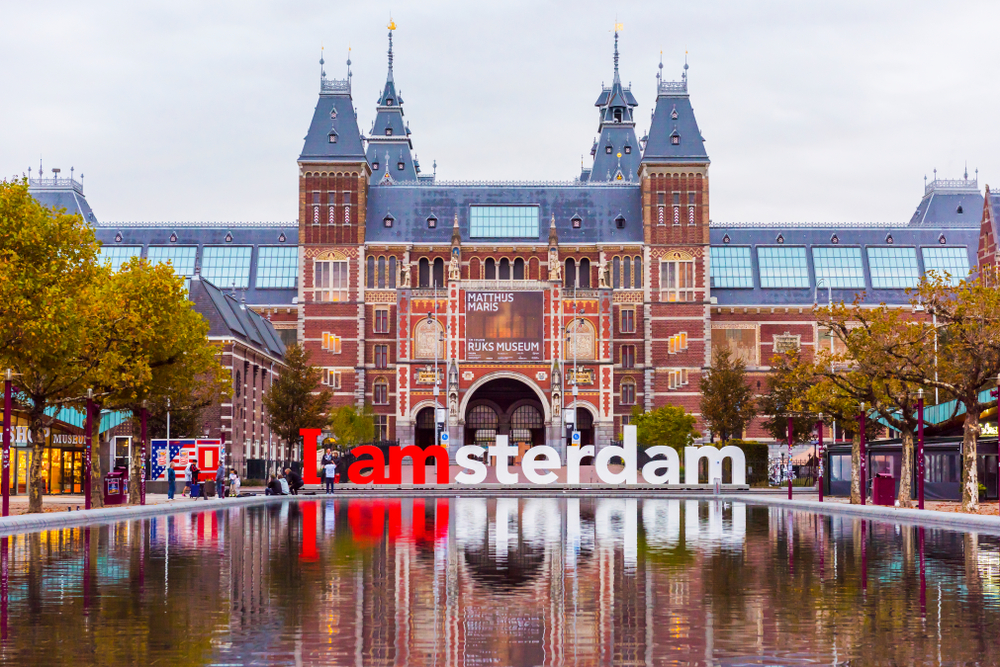 The I Amsterdam sign reflecting in the pool in front of the Rijksmuseum in Amsterdam.