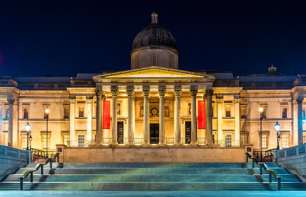 The National Gallery form the outside lit up at night. You can see the stairs and impressive building. 