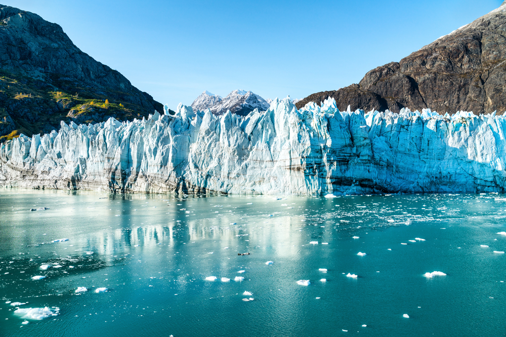 Glaciers with beautiful green water in foreground with ice chunks floating.