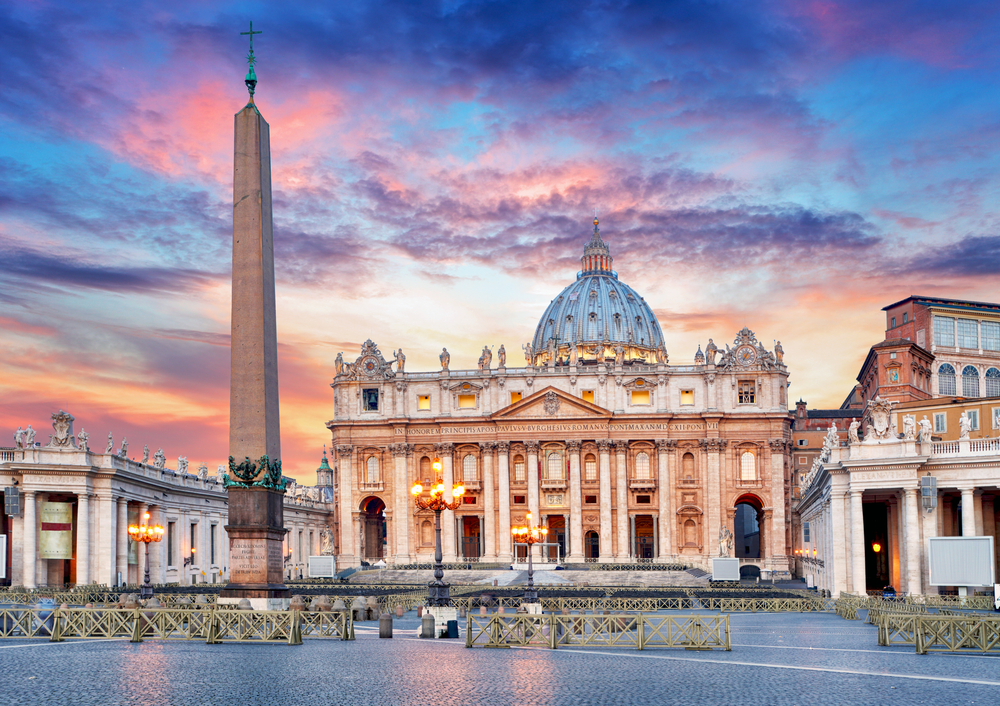 Vivid sunrise over St Peter Basilica and the square in front with no people.