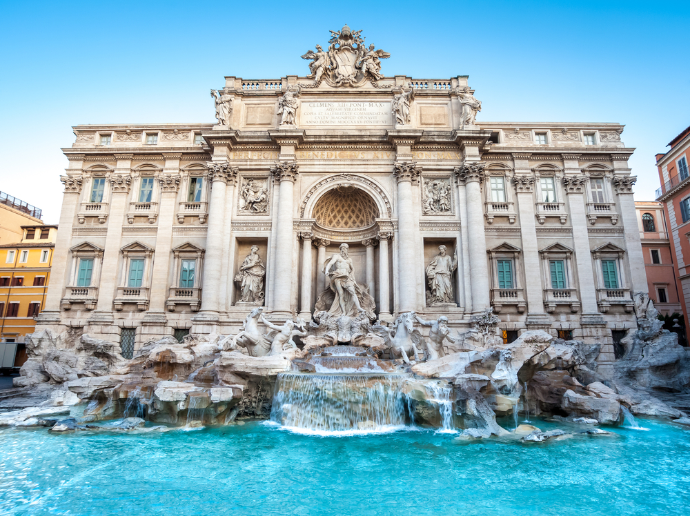 The intricate Trevi Fountain with statues and bright blue water.